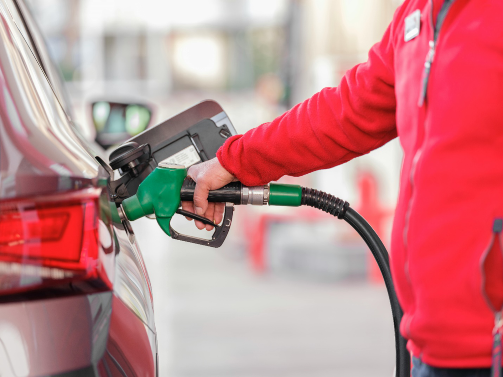 A person filling up fuel in a car